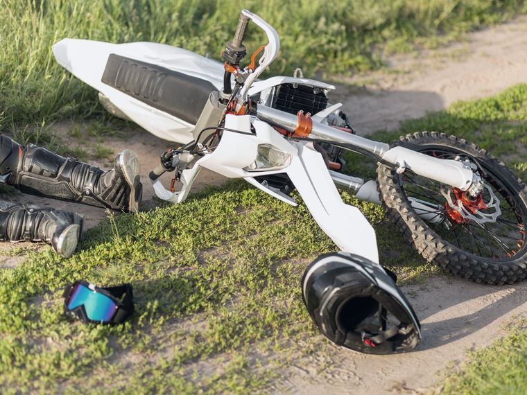 A two-wheeled vehicle on its side after a crash