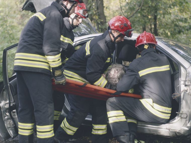 Emergency crews assisting a driver after a collision